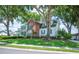 Beautiful home featuring a lush green lawn, mature trees, and well-maintained landscaping at 5425 Charlin Ave, Lakeland, FL 33810