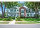 Charming two-story home boasts a brick and siding facade, complemented by lush landscaping and mature trees at 5425 Charlin Ave, Lakeland, FL 33810