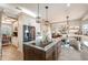Open-concept kitchen with center island, stainless steel appliances, and seamless flow into the dining area at 5425 Charlin Ave, Lakeland, FL 33810