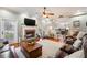 Inviting living room featuring a brick fireplace, hardwood floors, and abundant natural light at 5425 Charlin Ave, Lakeland, FL 33810