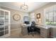 Bright office space with custom built-in desk, large window, and modern lighting at 5425 Charlin Ave, Lakeland, FL 33810