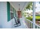 Cozy front porch with rocking chairs, decorative lighting, and charming details, offering a relaxing outdoor space at 5425 Charlin Ave, Lakeland, FL 33810