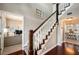 Elegant staircase featuring hardwood flooring and office and dining area access at 5425 Charlin Ave, Lakeland, FL 33810