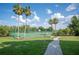 Community tennis court surrounded by lush landscaping and palm trees for recreation at 5425 Charlin Ave, Lakeland, FL 33810