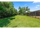 The lush backyard leads to a screened enclosure and offers plenty of space for outdoor activities at 5425 Lewellyn Rd, Lakeland, FL 33810