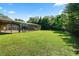 The backyard features a large screened enclosure and lush greenery, perfect for outdoor enjoyment at 5425 Lewellyn Rd, Lakeland, FL 33810