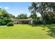 Wide view of the backyard showcasing green lawn and mature landscaping, adding natural beauty to the property at 5425 Lewellyn Rd, Lakeland, FL 33810