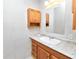 Bathroom with a white tile wall, granite counters, and a wood-paneled vanity at 5425 Lewellyn Rd, Lakeland, FL 33810