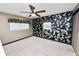 This bedroom offers a ceiling fan, carpet flooring, built-in closet, and windows for natural light at 5425 Lewellyn Rd, Lakeland, FL 33810