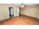 Cozy bedroom featuring wood floors, a ceiling fan, and neutral walls creating a peaceful space at 5425 Lewellyn Rd, Lakeland, FL 33810