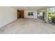 Carport with concrete flooring, white walls and trim, and view to backyard at 5425 Lewellyn Rd, Lakeland, FL 33810