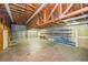 A spacious garage is well lit, has shelving and plenty of room for vehicles or storage at 5425 Lewellyn Rd, Lakeland, FL 33810