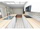 Updated kitchen with an island sink, open layout, and modern lighting fixtures at 5425 Lewellyn Rd, Lakeland, FL 33810