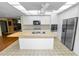 Bright kitchen features a large island, stainless steel appliances, and white cabinetry at 5425 Lewellyn Rd, Lakeland, FL 33810
