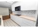 Modern kitchen with white cabinets, light countertops, and stainless steel appliances at 5425 Lewellyn Rd, Lakeland, FL 33810