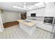 Well-lit kitchen features modern appliances, island with sink, and access to living space at 5425 Lewellyn Rd, Lakeland, FL 33810