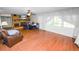 Living room with hardwood floors, a brick fireplace, and large windows at 5425 Lewellyn Rd, Lakeland, FL 33810