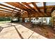 An open air patio has a stone floor, stone walls and wooden beamed roof with ceiling fans at 5425 Lewellyn Rd, Lakeland, FL 33810