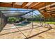 A screened in pool with a waterfall and beautiful stone flooring is a great place to relax and entertain at 5425 Lewellyn Rd, Lakeland, FL 33810