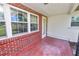 Covered porch with classic brick accents and ample natural light at 5425 Lewellyn Rd, Lakeland, FL 33810