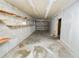 The ample storage room has built in shelves, concrete block walls and a bright overhead light at 5425 Lewellyn Rd, Lakeland, FL 33810