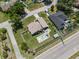 An aerial view showcases a well-maintained home with a backyard pool, firepit, shed, and manicured lawn at 5519 Club W Hl, Lakeland, FL 33812