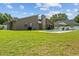 A sprawling backyard with a pool, patio, firepit, and lush green lawn, ideal for entertaining at 5519 Club W Hl, Lakeland, FL 33812