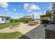 Landscaped backyard featuring a stone patio, dining area, and fire pit for outdoor enjoyment and entertaining at 5519 Club W Hl, Lakeland, FL 33812