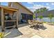 Outdoor patio with a built-in grill, a dining table and chairs, and lush landscaping for relaxation and entertainment at 5519 Club W Hl, Lakeland, FL 33812