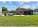 Expansive backyard features a fire pit, in-ground pool, and outdoor dining area, perfect for entertaining at 5519 Club W Hl, Lakeland, FL 33812