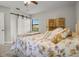 Cozy bedroom featuring a bed with floral bedding, and a barn door closet at 5519 Club W Hl, Lakeland, FL 33812