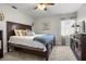 Comfortable bedroom featuring a large window, plush bedding, and ceiling fan at 5519 Club W Hl, Lakeland, FL 33812