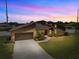 Striking shot of the property at sunset, highlighting the unique architectural design and landscaping at 5519 Club W Hl, Lakeland, FL 33812
