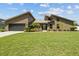 Inviting single-Gathering home featuring a well-manicured lawn and an attached two-car garage at 5519 Club W Hl, Lakeland, FL 33812