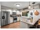 Well-lit kitchen features stainless steel appliances, granite countertops, ample cabinets, and a stylish subway tile backsplash at 5519 Club W Hl, Lakeland, FL 33812