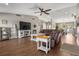 Bright living room features hardwood floors, a large TV, and comfortable seating at 5519 Club W Hl, Lakeland, FL 33812