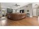 Spacious living room with hardwood floors, a dark fireplace, and a large leather sofa at 5519 Club W Hl, Lakeland, FL 33812