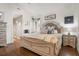 Comfortable main bedroom featuring a king bed, wood floors, and decorative accents at 5519 Club W Hl, Lakeland, FL 33812