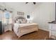Cozy main bedroom showcasing a decorative headboard, wood floors, and modern decor at 5519 Club W Hl, Lakeland, FL 33812