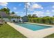 A refreshing in-ground swimming pool with umbrella and lounge chairs, perfect for outdoor relaxation at 5519 Club W Hl, Lakeland, FL 33812