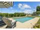 Inviting in-ground pool surrounded by a well-manicured lawn and chair, ideal for relaxation at 5519 Club W Hl, Lakeland, FL 33812