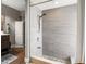 Modern shower with gray tile walls and pebble stone flooring at 5519 Club W Hl, Lakeland, FL 33812