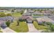 An aerial view showcases this charming home in a well-kept neighborhood with manicured lawns and mature trees at 555 Heather Glen Dr, Winter Haven, FL 33884