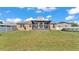 The spacious backyard showcases a well-kept lawn, enclosed patio, and surrounding fence at 555 Heather Glen Dr, Winter Haven, FL 33884