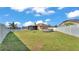 Expansive backyard with lush green lawn, enclosed by a white fence, ideal for outdoor activities at 555 Heather Glen Dr, Winter Haven, FL 33884