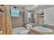 Bathroom featuring a tub-shower combo with gray tile, updated fixtures, and decorative curtain at 555 Heather Glen Dr, Winter Haven, FL 33884