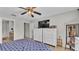 Comfortable bedroom featuring dual dressers, TV, ceiling fan, and neutral paint at 555 Heather Glen Dr, Winter Haven, FL 33884