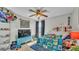 Fun and colorful bedroom with a ceiling fan and plenty of shelving at 555 Heather Glen Dr, Winter Haven, FL 33884