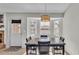 Bright dining area features bay window, stylish lighting, and neutral colors at 555 Heather Glen Dr, Winter Haven, FL 33884