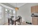Bright dining area with large windows and a decorative light fixture at 555 Heather Glen Dr, Winter Haven, FL 33884